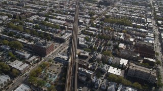 4K aerial stock footage of flying by railroad tracks and row houses, Brooklyn, New York Aerial Stock Footage | AX88_034