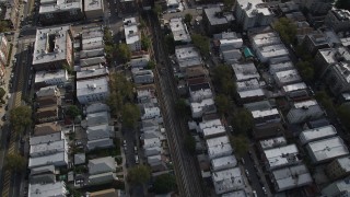 4K aerial stock footage of following railroad tracks through urban neighborhood in Brooklyn, New York Aerial Stock Footage | AX88_038