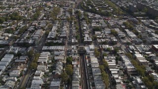 4K aerial stock footage of following railroad tracks and flying over urban neighborhoods, Brooklyn, New York Aerial Stock Footage | AX88_040