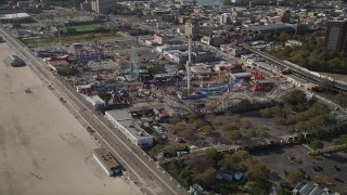 4K aerial stock footage of flying by Luna Park rides in Coney Island, Brooklyn, New York City, New York Aerial Stock Footage | AX88_045