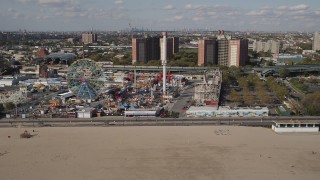 4K aerial stock footage flyby a roller coaster and Ferris wheel at Luna Park, Coney Island, Brooklyn, New York Aerial Stock Footage | AX88_047