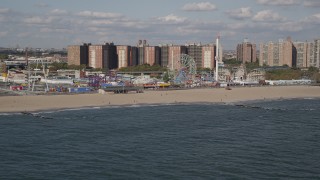 4K aerial stock footage tilt from Atlantic Ocean, reveal Luna Park and Coney Island Beach, Brooklyn, New York Aerial Stock Footage | AX88_054