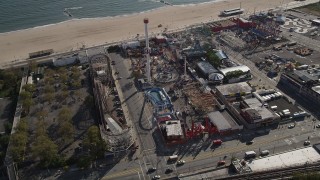 4K aerial stock footage of flying by Luna Park's beachfront rides in Coney Island, Brooklyn, New York, New York Aerial Stock Footage | AX88_058