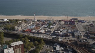 4K aerial stock footage of flying away from rides and beach at Luna Park, Coney Island, Brooklyn, New York Aerial Stock Footage | AX88_059