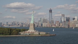 4K aerial stock footage approach Statue of Liberty, with Lower Manhattan skyline in background, New York Aerial Stock Footage | AX88_096