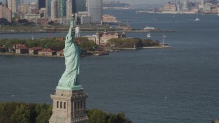 AX88_098 - 4K aerial stock footage of flying by Statue of Liberty, with Ellis Island in background, New York, New York