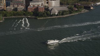 4K aerial stock footage of tracking a ferry on the Hudson River, Lower Manhattan, New York, New York Aerial Stock Footage | AX88_156