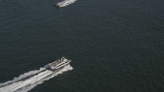 4K aerial stock footage of two passing ferries on the Hudson River, New York, New York Aerial Stock Footage | AX88_158