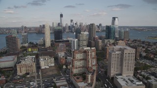 AX88_172 - 4K aerial stock footage of city skyscrapers and Lower Manhattan skyline in background, Downtown Jersey City, New Jersey