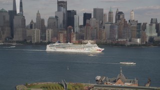 4K aerial stock footage of a cruise ship sailing past Lower Manhattan skyline, New York, New York Aerial Stock Footage | AX88_175