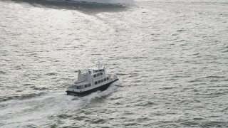 4K aerial stock footage orbiting a small ferry sailing New York Harbor, New York, New York Aerial Stock Footage | AX88_183