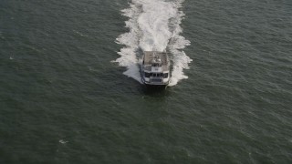 4K aerial stock footage of tracking a ferry cruising across New York Harbor, New York Aerial Stock Footage | AX88_190