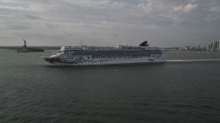 4K aerial stock footage of a cruise ship sailing New York Harbor near Statue of Liberty, New York, New York Aerial Stock Footage | AX88_192