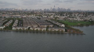 4K aerial stock footage of flying by waterfront condominiums, Lower Manhattan skyline in background, Jersey City, New Jersey Aerial Stock Footage | AX88_202