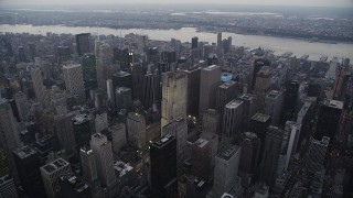 AX89_065 - 4K aerial stock footage Flying by skyscrapers, Midtown Manhattan, New York, New York, twilight