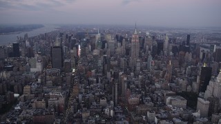 4K aerial stock footage Approaching Midtown Manhattan, Empire State Building, New York, twilight Aerial Stock Footage | AX89_080