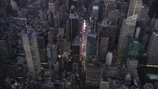 AX89_083 - 4K aerial stock footage Approaching Times Square, Midtown Manhattan, tilt down, New York, twilight