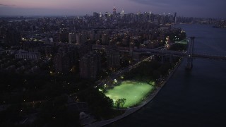 AX89_110 - 4K aerial stock footage Approaching Midtown Manhattan, from Lower East Side, New York, twilight