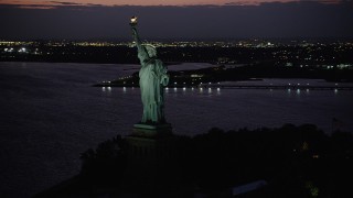 4K aerial stock footage Flying by Statue of Liberty, Liberty Island, New York, New York, twilight Aerial Stock Footage | AX89_139