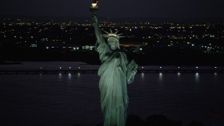 4K aerial stock footage Flying by Statue of Liberty, Liberty Island, New York, New York, night Aerial Stock Footage | AX89_140