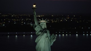 4K aerial stock footage Flying by the Statue of Liberty, Liberty Island, New York, New York, night Aerial Stock Footage | AX89_141