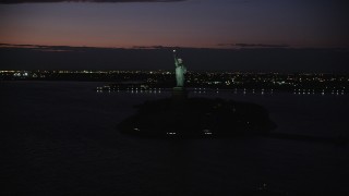 4K aerial stock footage Flying by Statue of Liberty, Liberty Island, New York, New York, night Aerial Stock Footage | AX89_145