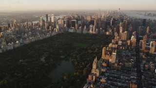 AX90_042 - 4K aerial stock footage Flying by Central Park, approaching Midtown Manhattan, New York, sunrise