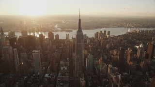 AX90_050 - 4K aerial stock footage Flying by Empire State Building, Midtown Manhattan, New York, sunrise