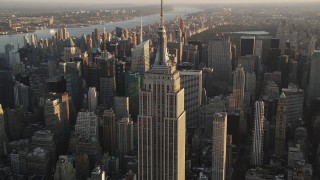 AX90_052 - 4K aerial stock footage Flying by Empire State Building, Midtown Manhattan, New York, sunrise