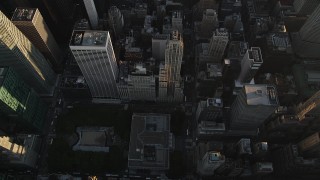 AX90_074 - 4K aerial stock footage of New York Public Library, Rockefeller Center, Central Park, New York, sunrise