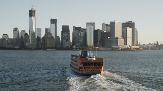 4K aerial stock footage Flying by Staten Island Ferry, Lower Manhattan, New York, New York, sunrise Aerial Stock Footage | AX90_132