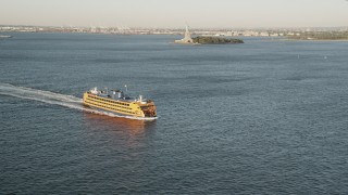 4K aerial stock footage Flying by Staten Island Ferry on New York Harbor, New York, New York, sunrise Aerial Stock Footage | AX90_133