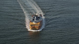 4K aerial stock footage Tracking the Staten Island Ferry on New York Harbor, New York, sunrise Aerial Stock Footage | AX90_134