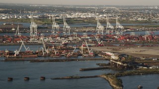 4K aerial stock footage Approaching cargo cranes, containers, Port Jersey, New Jersey, sunrise Aerial Stock Footage | AX90_153