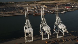 4K aerial stock footage Approaching cargo cranes, tilt down, Port Jersey, New Jersey, sunrise Aerial Stock Footage | AX90_158