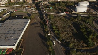 AX90_159 - 4K aerial stock footage Tracking a commuter train, Jersey City, New Jersey, sunrise