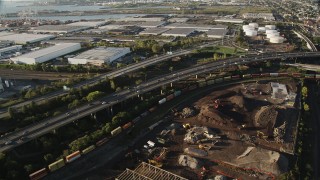 AX90_166 - 4K aerial stock footage Flying by New Jersey Turnpike Extension, Jersey City, New Jersey, sunrise