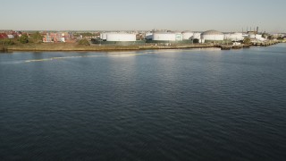 AX90_170 - 4K aerial stock footage Flying by an oil refinery, Newark, New Jersey, sunrise