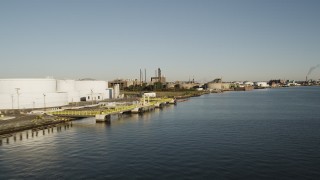 AX90_171 - 4K aerial stock footage Flying by an oil refinery, Newark, New Jersey, sunrise