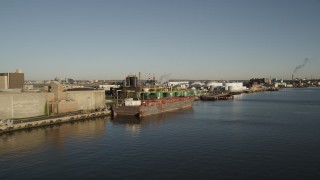 AX90_172 - 4K aerial stock footage Flying by an oil refinery, Newark, New Jersey, sunrise