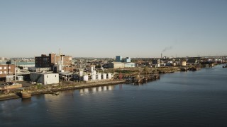 AX90_174 - 4K aerial stock footage Flying by industrial buildings, Newark, New Jersey, sunrise