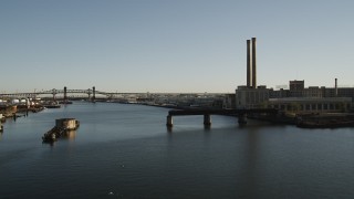 4K aerial stock footage Flying by a factory on the water, Kearny, New Jersey, sunrise Aerial Stock Footage | AX90_175