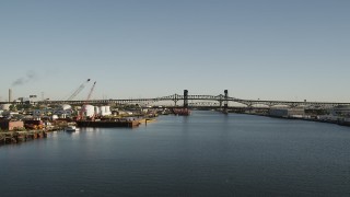 AX90_176 - 4K aerial stock footage of Industrial buildings, Lincoln Highway Bridge, Pulaski Skyway Bridge, Newark, New Jersey, sunrise