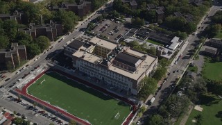 AX91_024 - 4K aerial stock footage approach Christopher Columbus High School and tilt to a bird's eye view of the building, The Bronx, New York