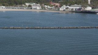 AX91_049 - 4K aerial stock footage tilt from water to Playland amusement park and beach, Rye ,New York