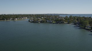 4K aerial stock footage of flying by oceanfront homes on the coast in Greenwich, Connecticut Aerial Stock Footage | AX91_065