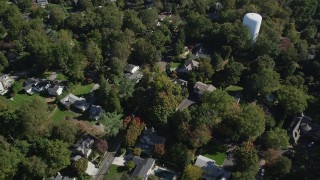 4K aerial stock footage of tilting to suburban homes and neighborhoods with trees in Norwalk, Connecticut Aerial Stock Footage | AX91_094