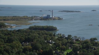 AX91_095 - 4K aerial stock footage of a factory building with a smoke stack in Norwalk, Connecticut