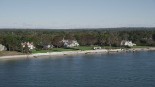 AX91_107 - 4K aerial stock footage of flying by beachfront mansions on the shore, Westport, Connecticut