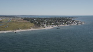 AX91_119 - 4K aerial stock footage tilt from Long Island Sound, reveal homes and beach, Stratford, Connecticut